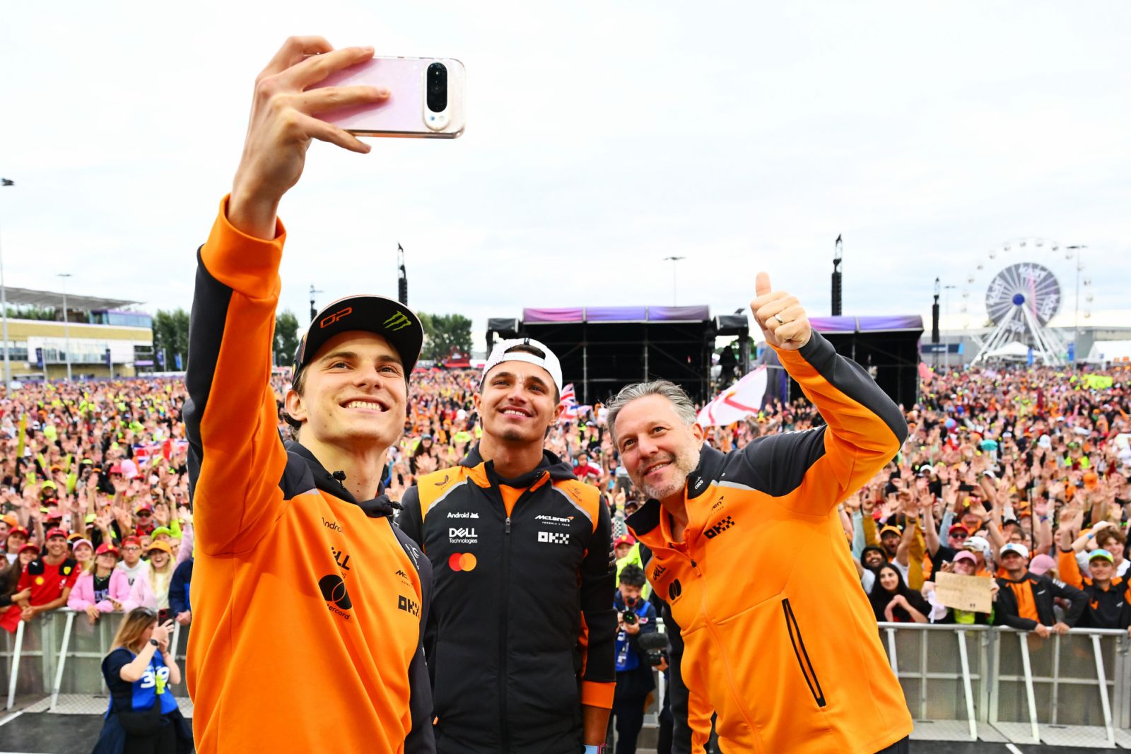 NORTHAMPTON, ENGLAND - JULY 06: Second placed Oscar Piastri of Australia and McLaren, Race winner Lando Norris of Great Britain and McLaren and Zak Brown, Chief Executive Officer of McLaren on the fan stage after the F1 Grand Prix of Great Britain at Silverstone Circuit on July 06, 2025 in Northampton, England. (Photo by Mark Sutton - Formula 1/Formula 1 via Getty Images)