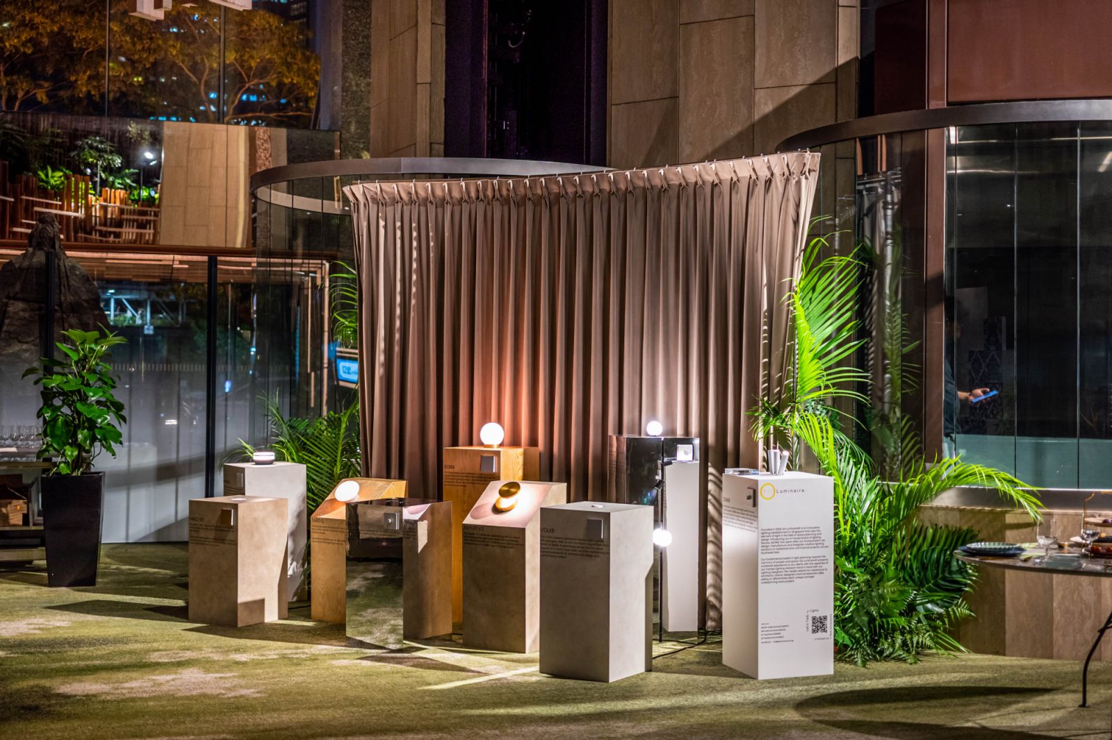 A landscape of Sol Luminaire’s pedestal-mounted wall lights complemented with Coesa curtain