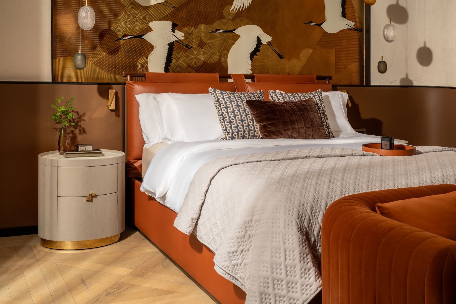 A bedroom clad in rich, warm jewel tones in a Hong Kong multigenerational home designed by Liquid Interiors