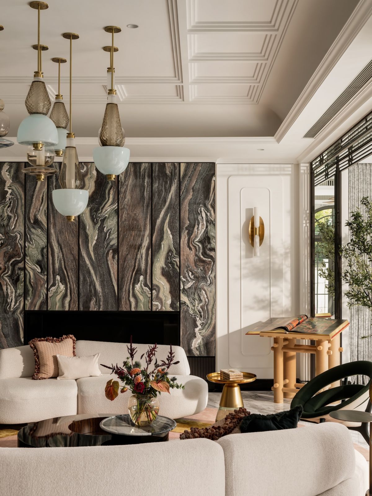 The living room in a Hong Kong multigenerational home featuring lighting fixtures by Gabriel Scott, designed by Liquid Interiors