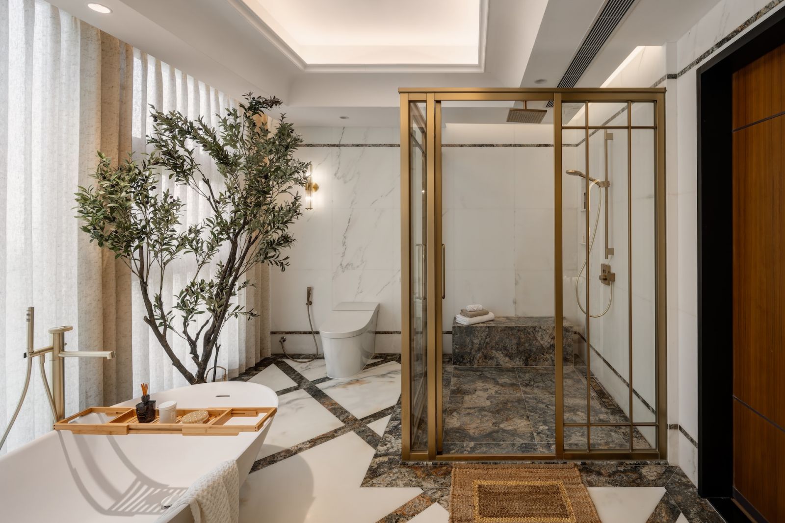 A bathroom with neutral hues, balancing marble and metallic accents in a Hong Kong multigenerational home designed by Liquid Interiors
