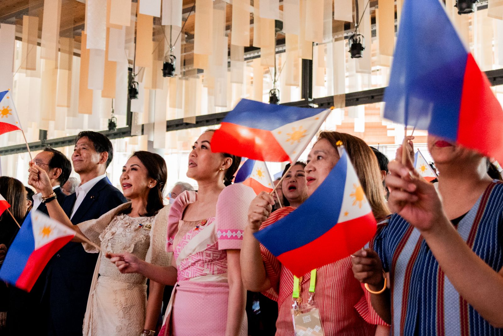 Department of Tourism Secretary Christina Garcia Frasco, Tourism Promotions Board COO Maria Margarita Montemayor Nograles, and Philippine Ambassador to Japan Mylene Garcia-Albano gleefully led the crowd in waving Philippine flags during the finale of the National Day program at the Philippine Pavilion in Expo 2025 Osaka (Photo: Tourism Promotions Board Philippines)