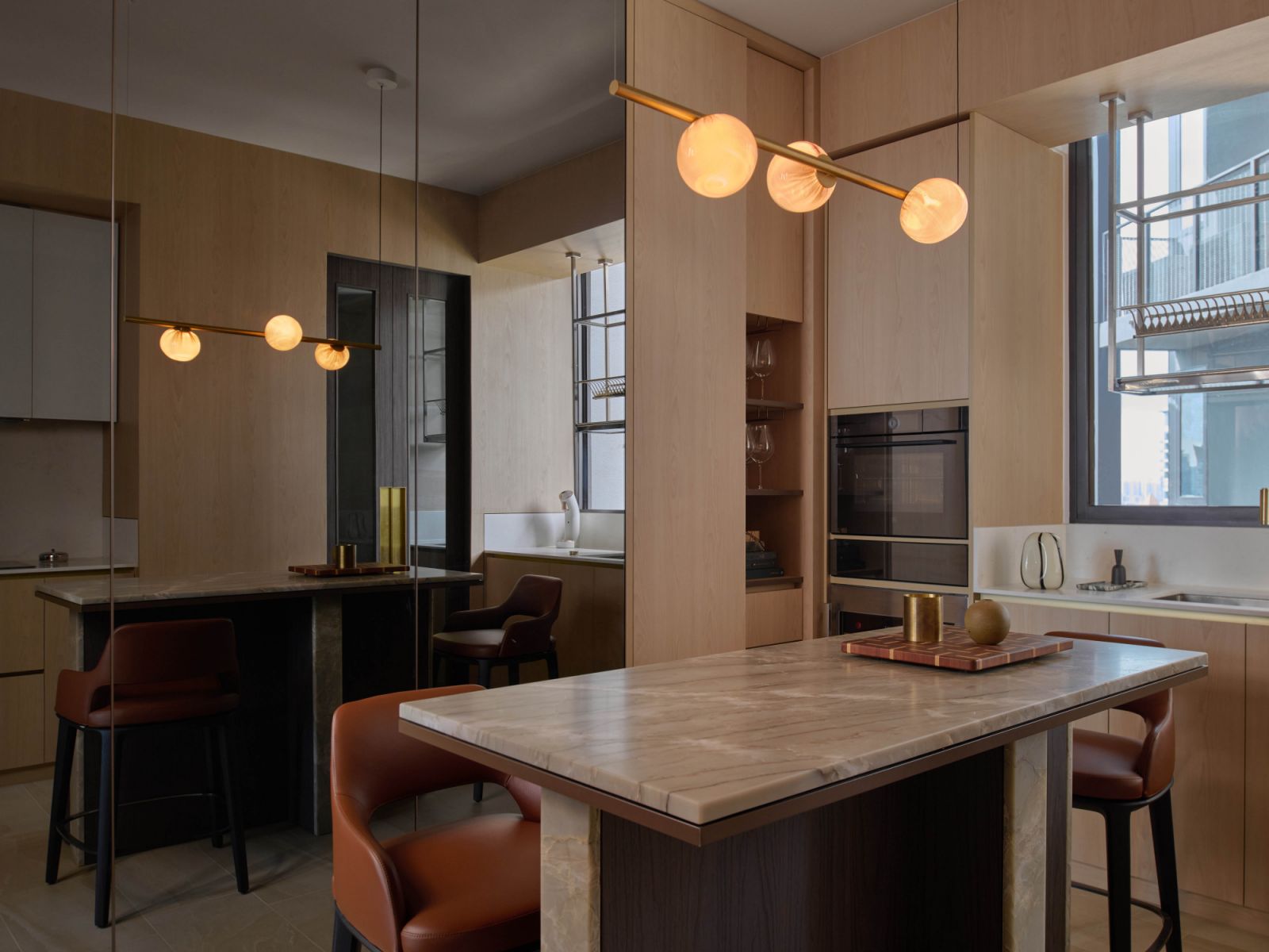 Bocci ceiling lights glow softly in the abode’s elevated dry kitchen