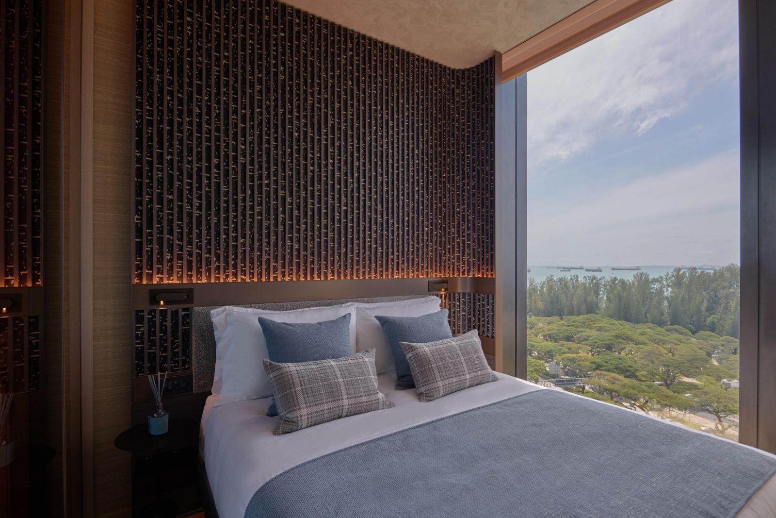 Scenes of Singapore’s coastal greenery enliven the elegant master suite
