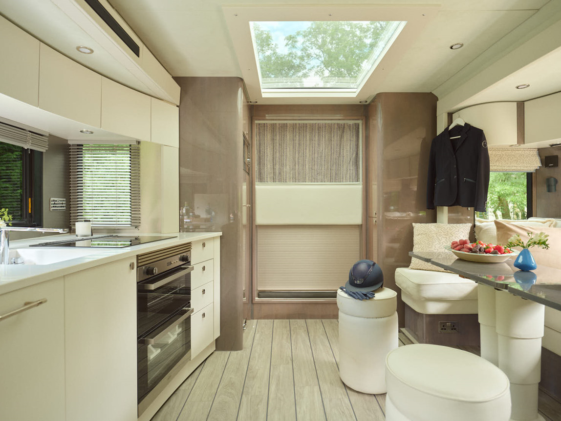 The interior combines a fully equipped kitchen with comfortable seating areas, featuring hardwearing Amtico flooring designed to withstand muddy boots and outdoor life