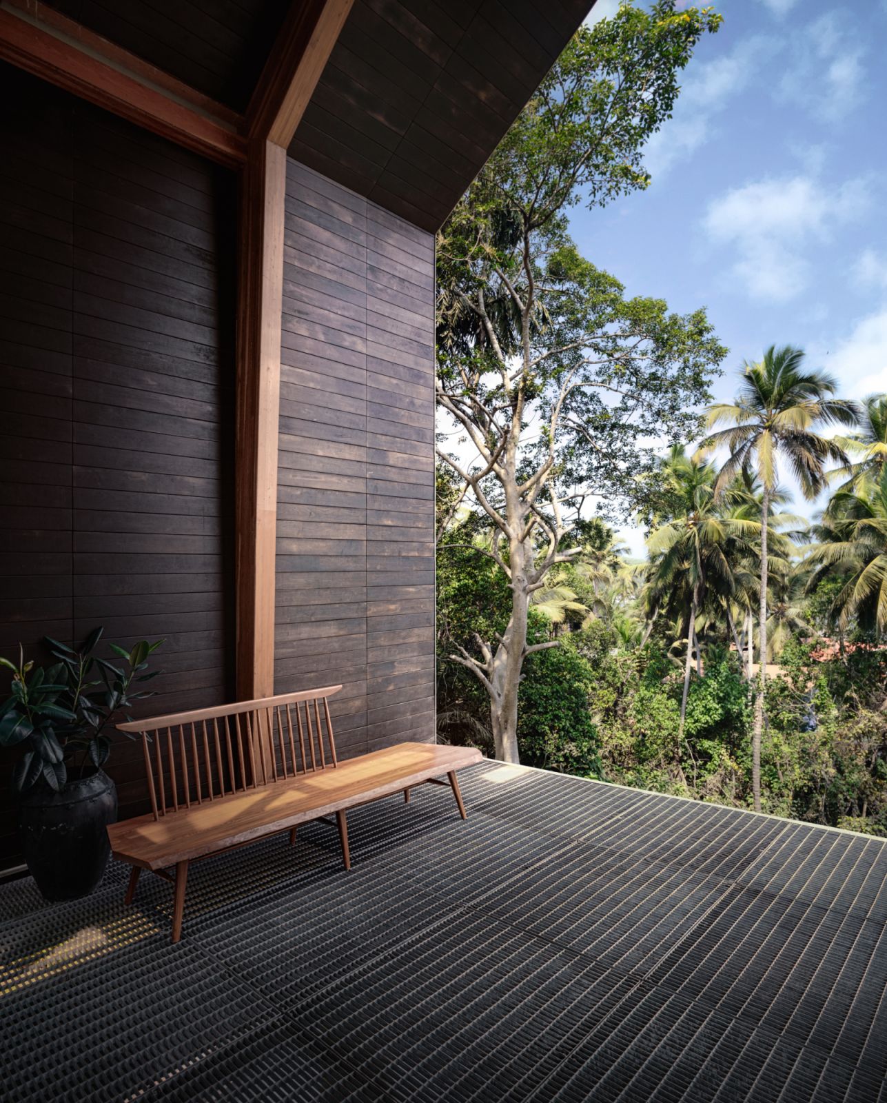 The partially shaded timber deck connects to the expansive outdoor