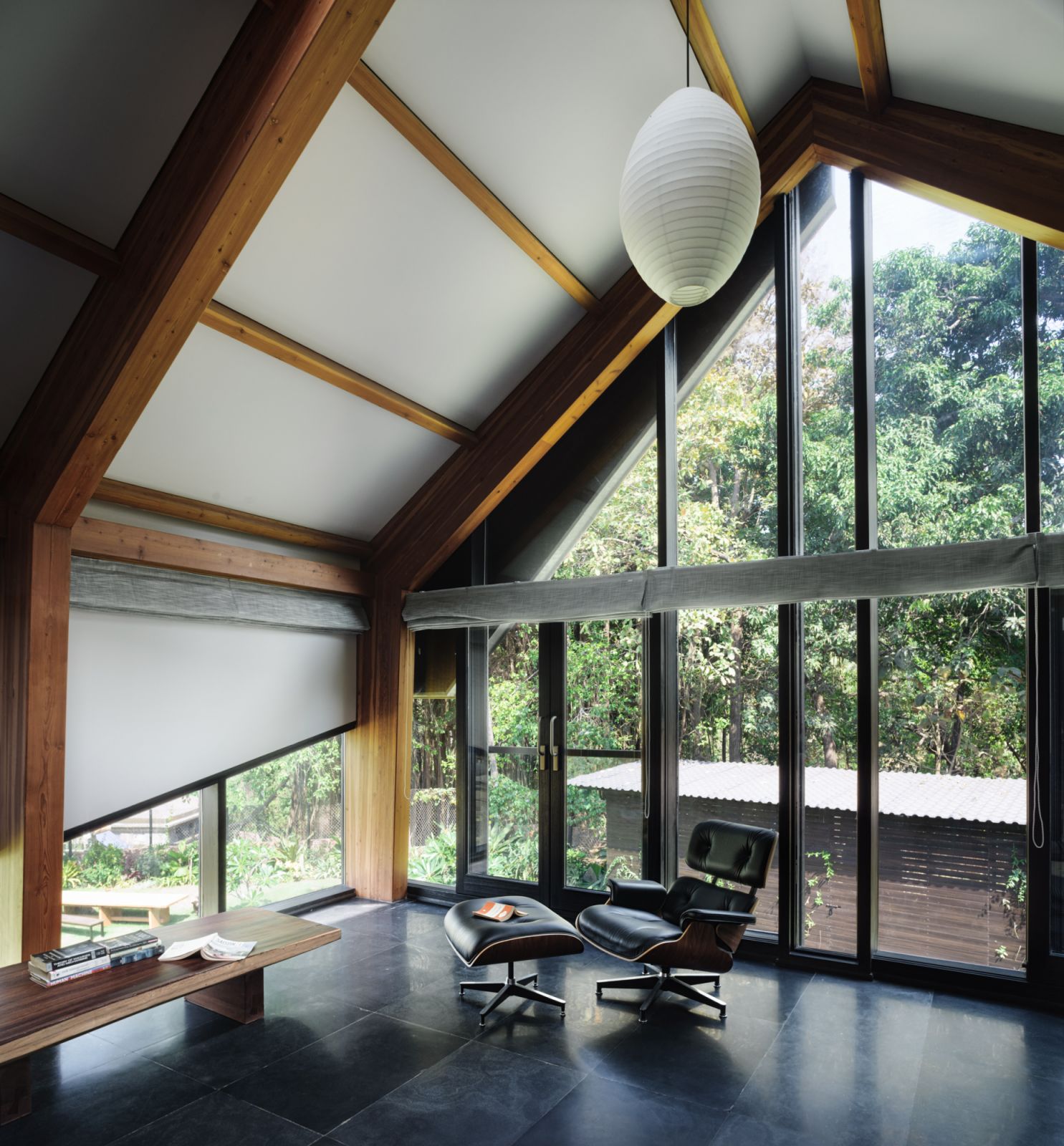Furniture selection balances simplicity with elegance across the open-plan layout with black granite flooring
