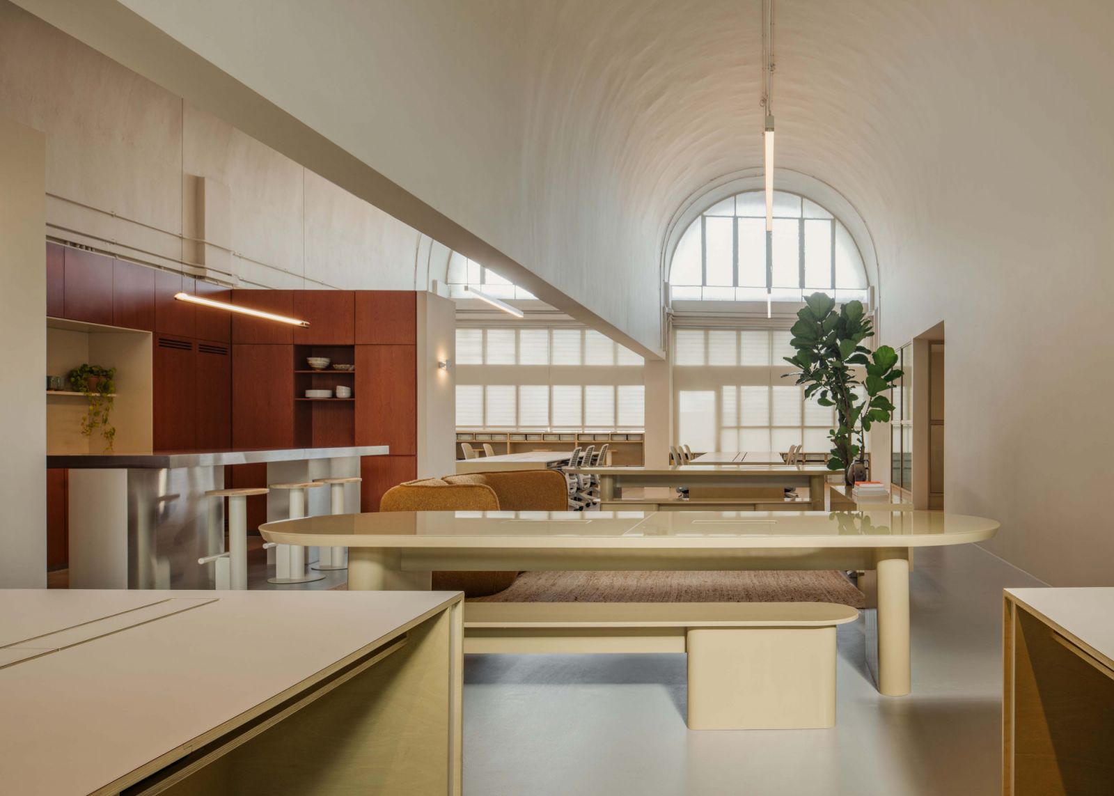 Vie to the barrel-vault windows across the communal table at the office