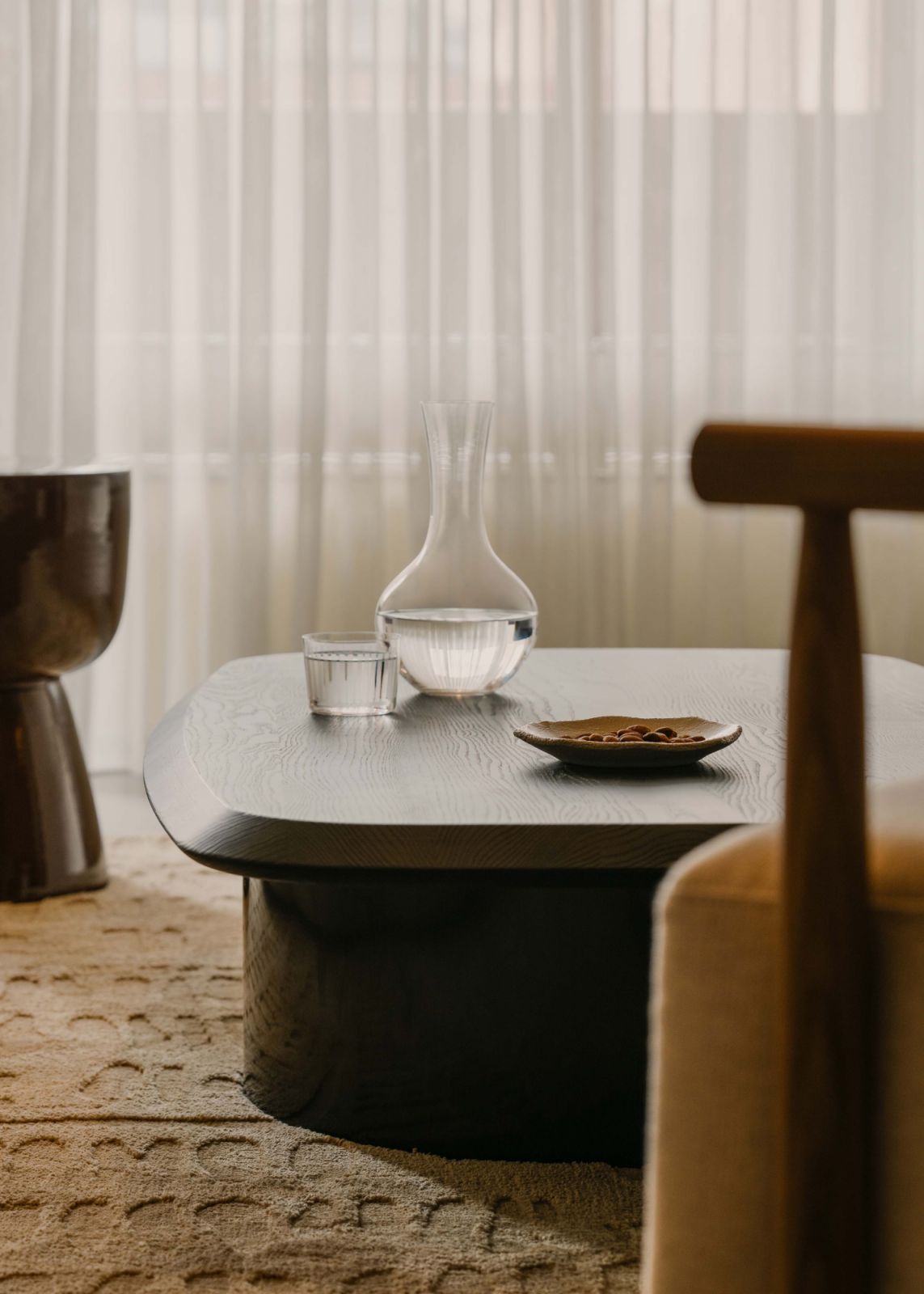 Semi-translucent curtain and low-slung furniture add the residential-like ambience of the office