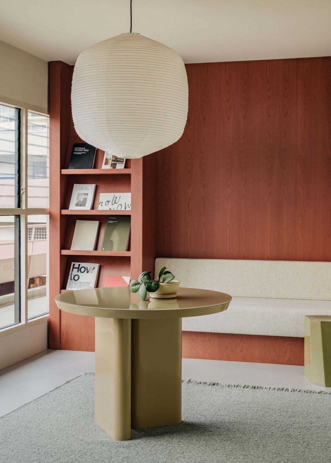 The main office’s small reception area, with a custom-designed table and Hotaru paper lamp from Ozeki and Co, designed by Barber Osgerby
