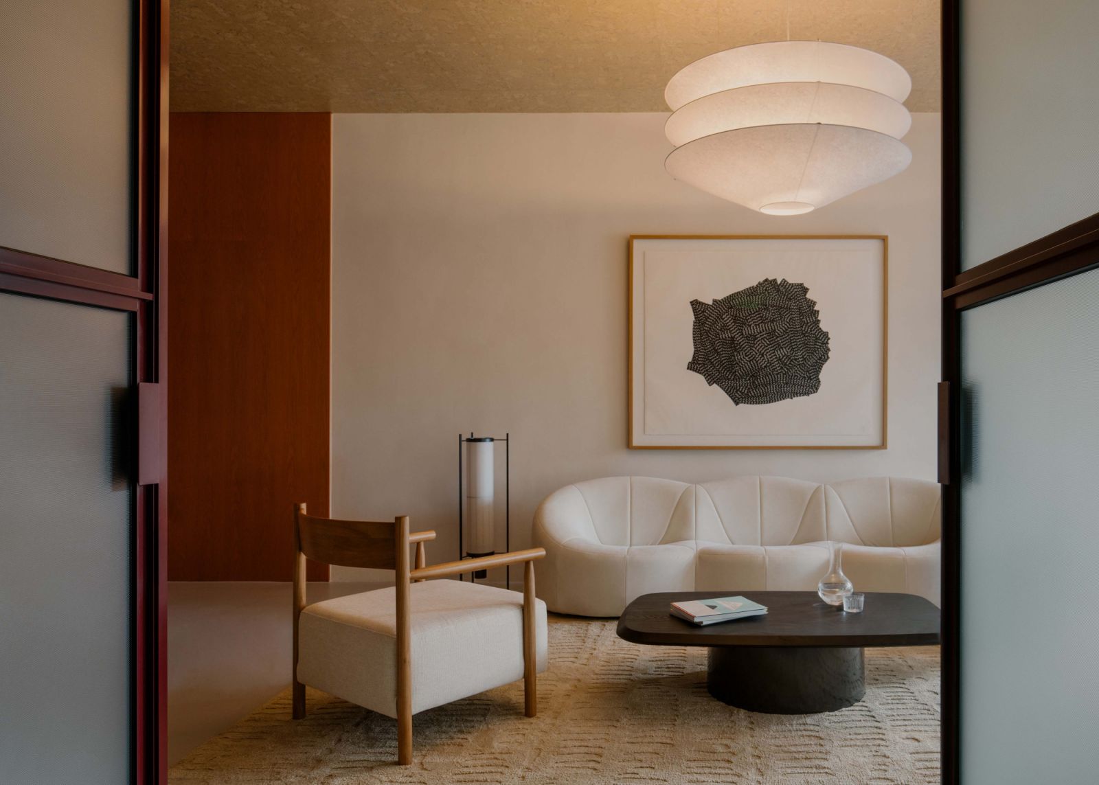 In the reception area of the Lo & Behold Group’s office are Pumpkin sofa from Ligne Roset, Richard Deacon print and pendant from Ingo Maurer