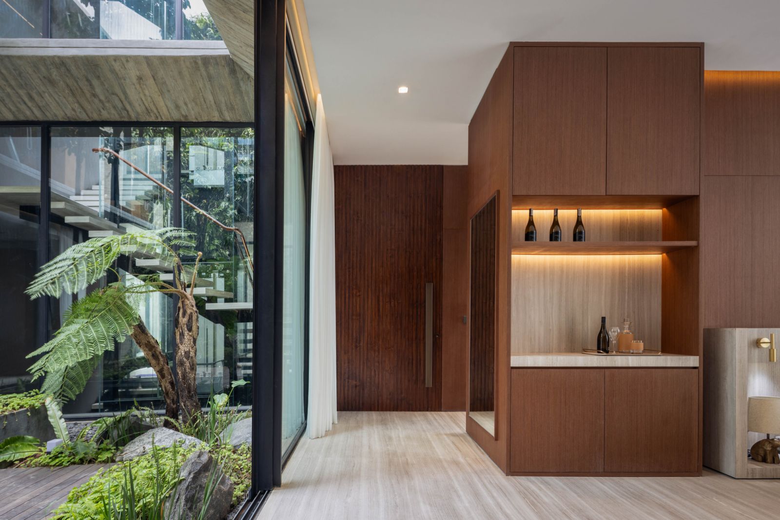 To balance the large built area, the house is dotted with pockets of greenery as in this courtyard between the two wings