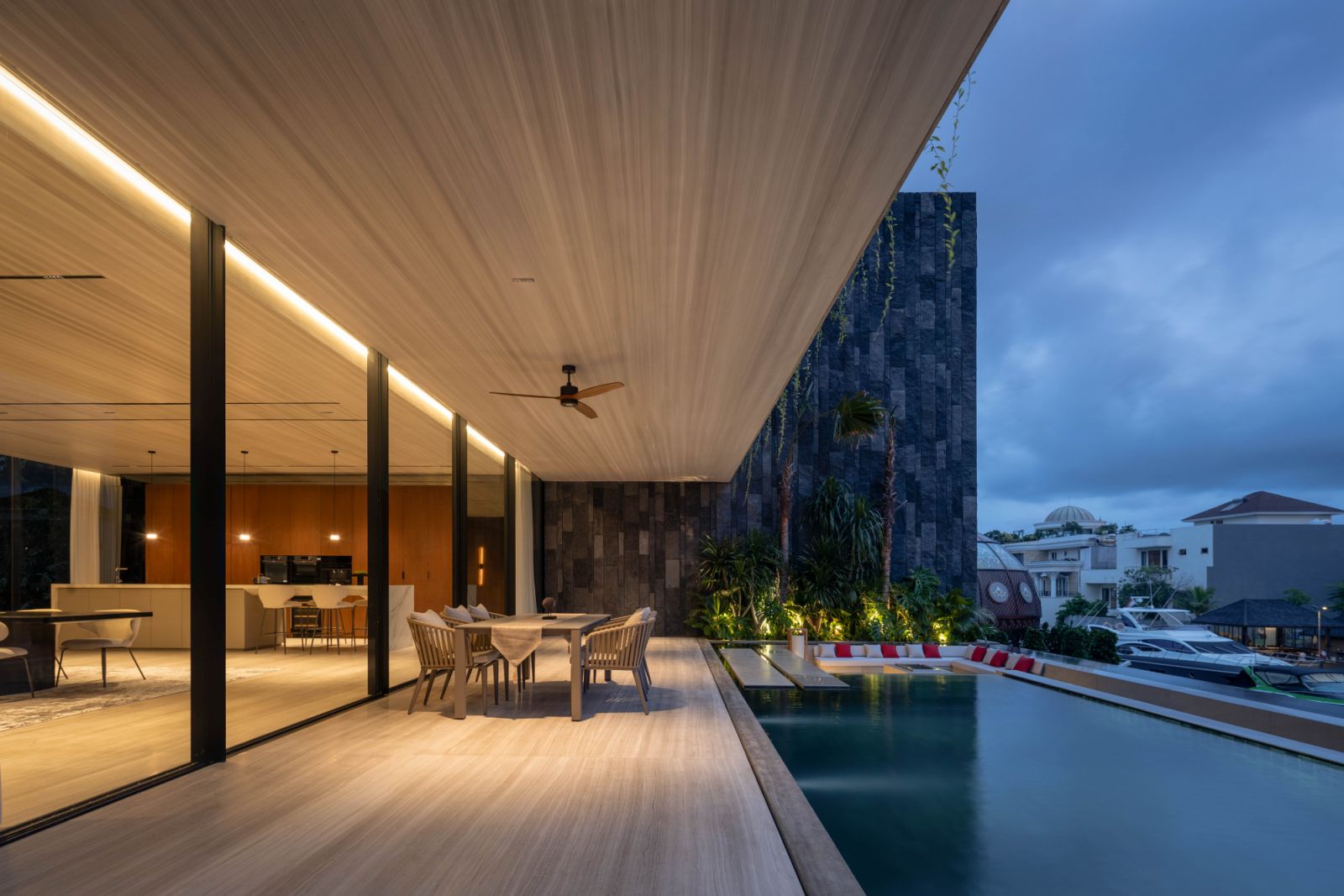 The tropical home stands as a striking landmark along the busy street