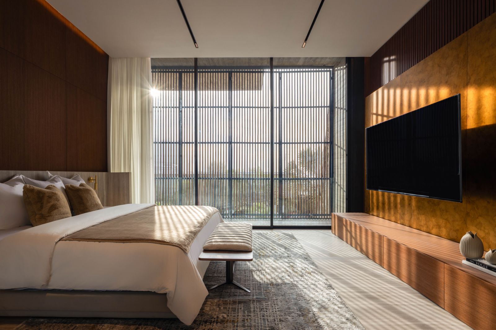 One of the bedrooms facing the street opposite a popular cafe, which can be shielded from view by timber screens