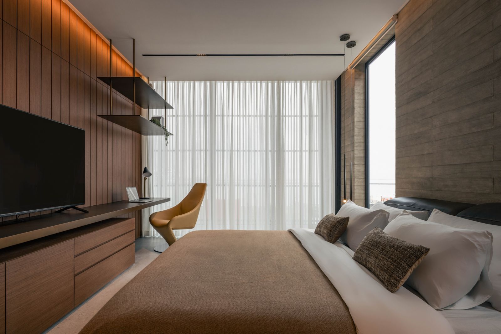 A corner study in this bedroom features hanging shelves for a touch of industrial chic