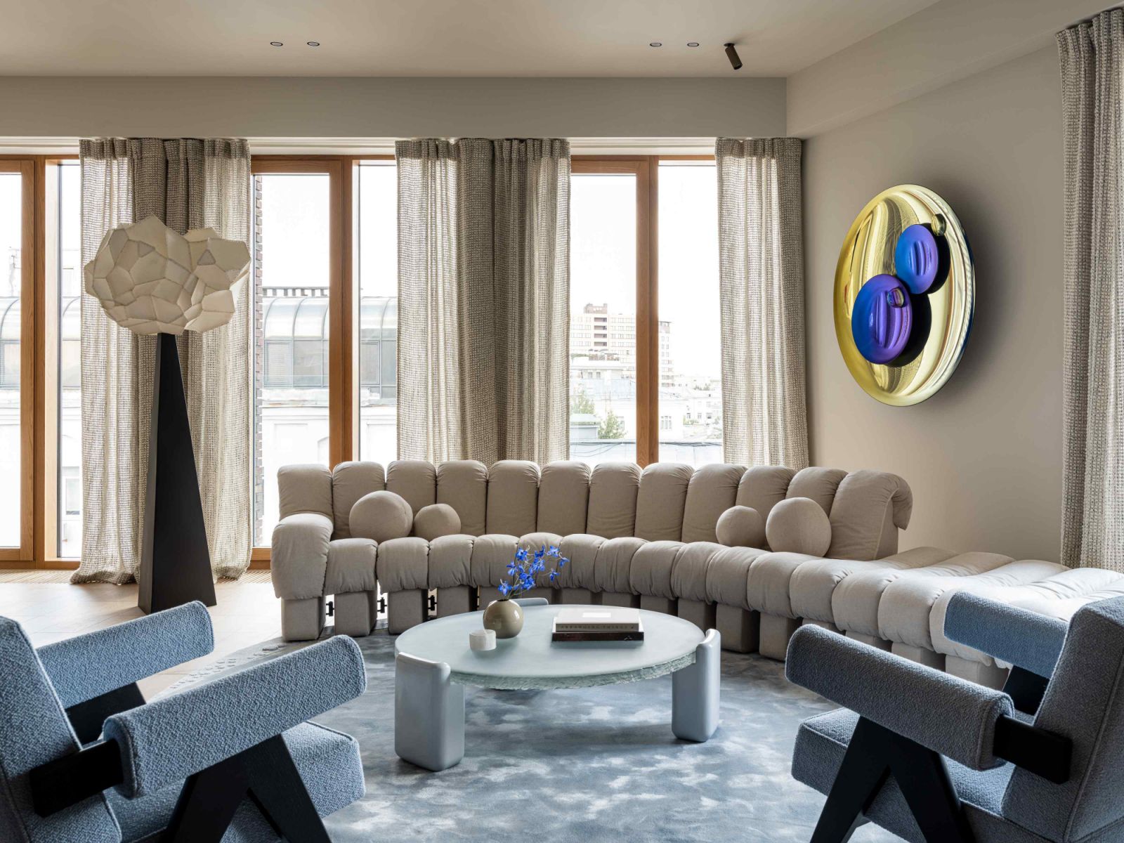 Wool curtains with thick weaving reminiscent of chainmail hang at the expansive windows