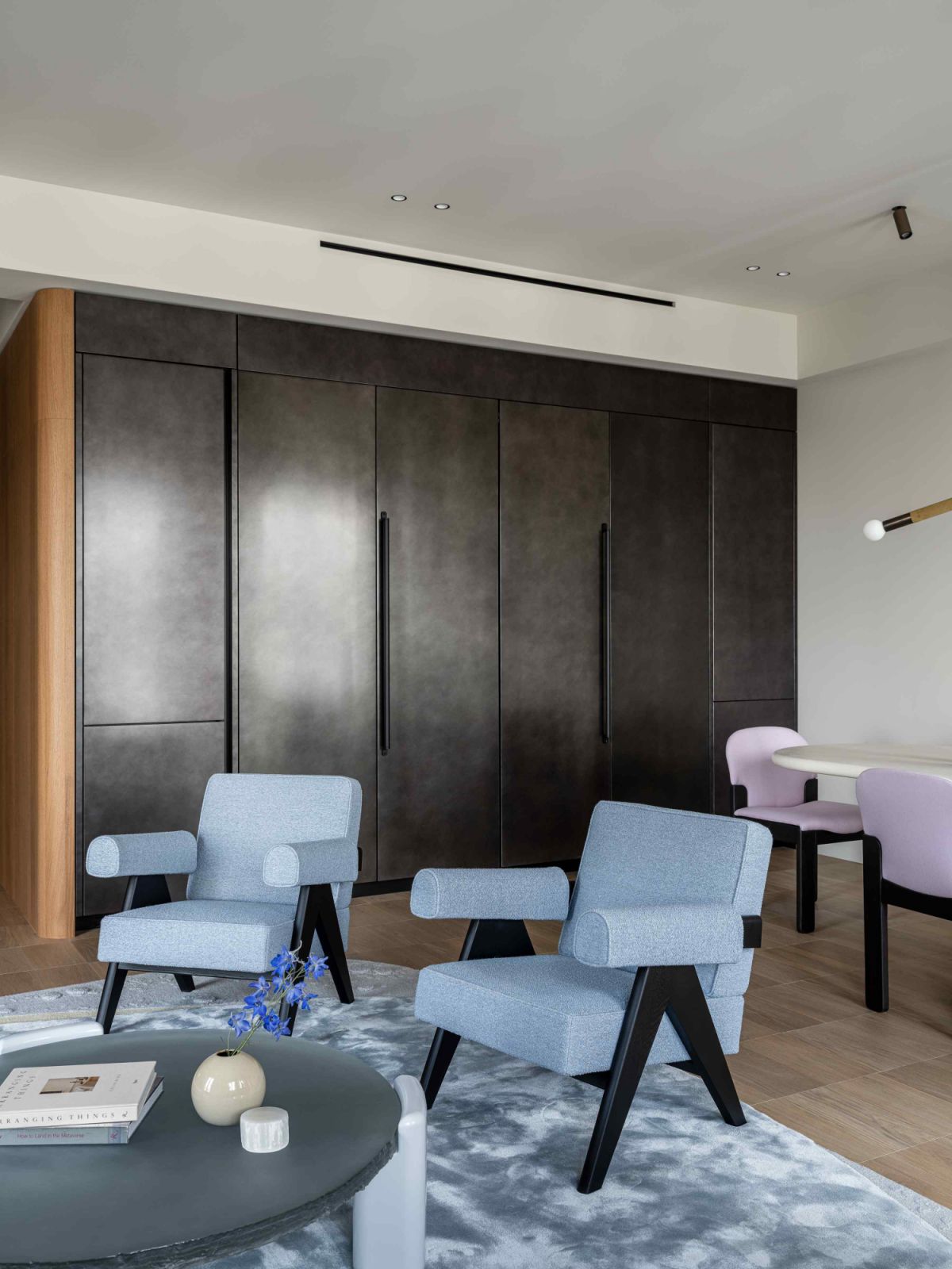 The hidden kitchenette elegantly concealed behind foldable metallic façades