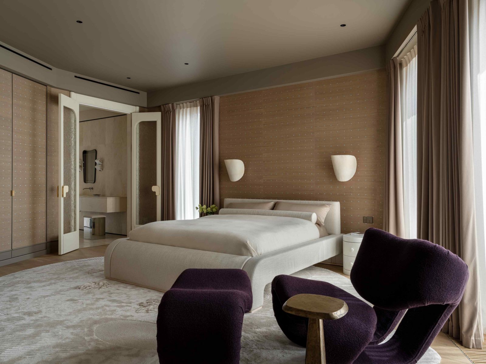 The neutral-toned master bedroom across the hallway