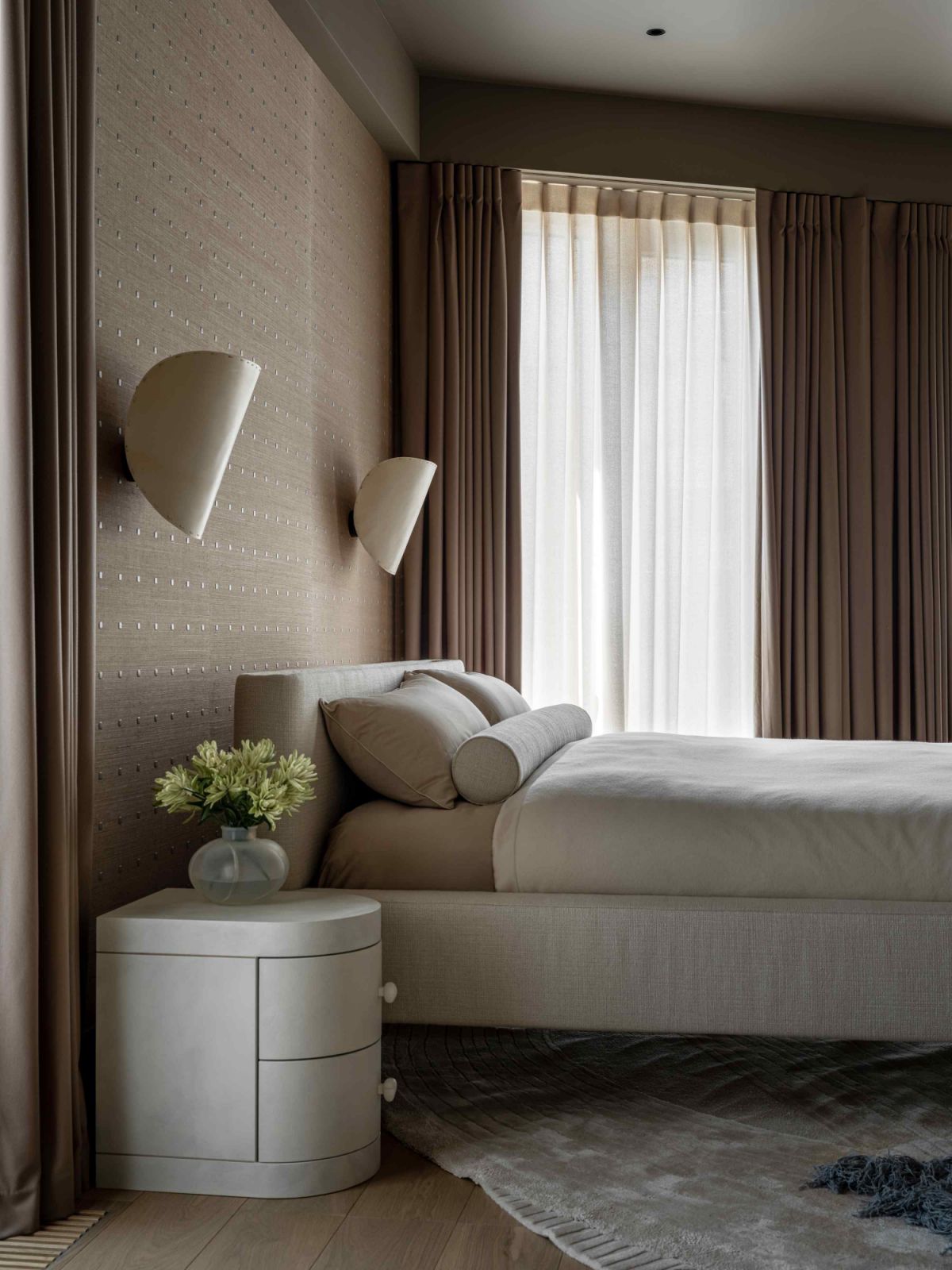 A tranquil retreat featuring custom-made bed, bedside table, side table, and rug
