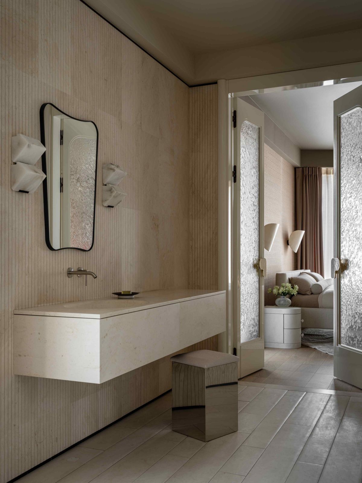 The master bathroom features Salvatori stone, creating a soft, enveloping effect throughout the space