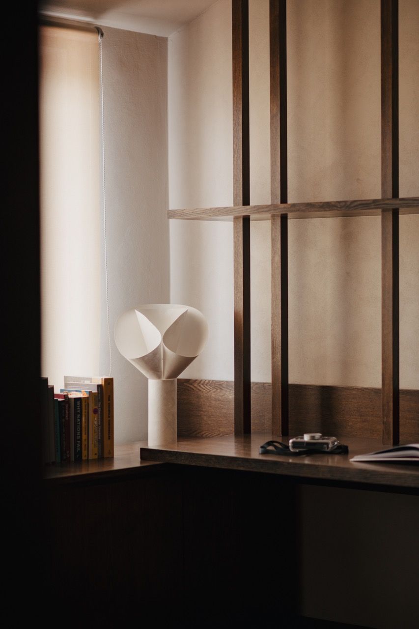 Custom shelving detail showing the open niches designed for books and decorative items, part of the feature wall approach rather than generic linear cabinetry