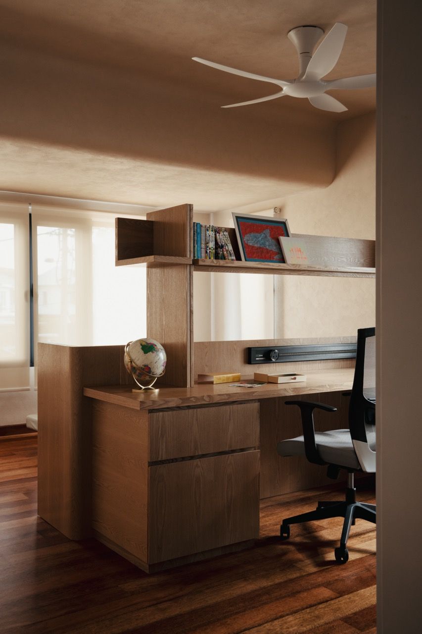 The master bedroom’s home office space, where Lim reconfigured the layout to create a functional workspace separated from the sleeping area by the existing structural column