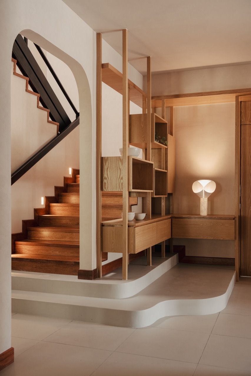The staircase detail shows the integrated lighting and the customised cabinetry