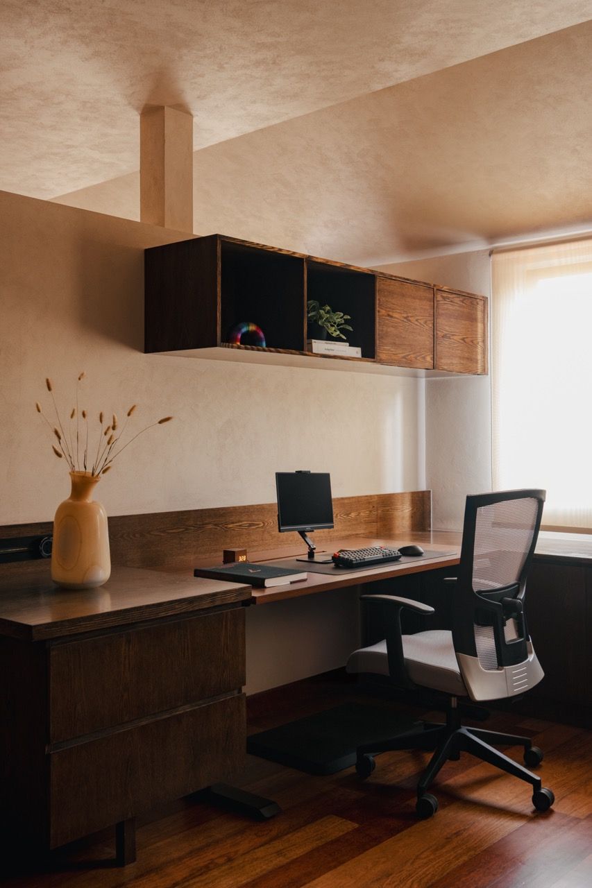 The home office area featuring the Senply timber veneer and the sand-infused Murobond paint that creates subtle texture responding to light throughout the house