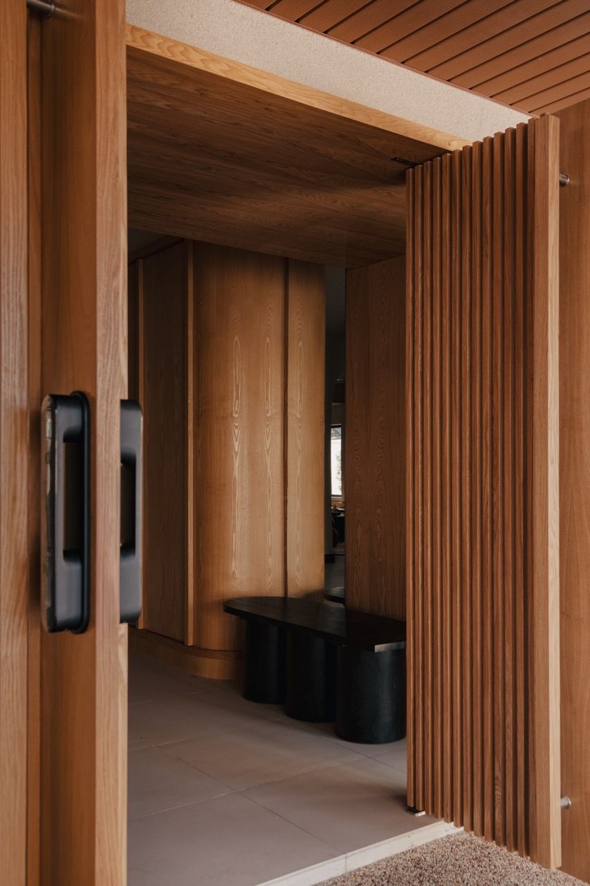 The entrance area features Senply timber slat detailing and the textured Murobond paint finish