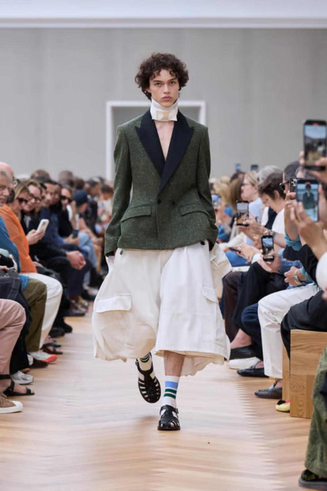 Dior’s heritage pieces—such as the Bar jacket, pleated cargo trousers, and classic sandals—are all showcased in Look 1 of the collection (photo: Dior)