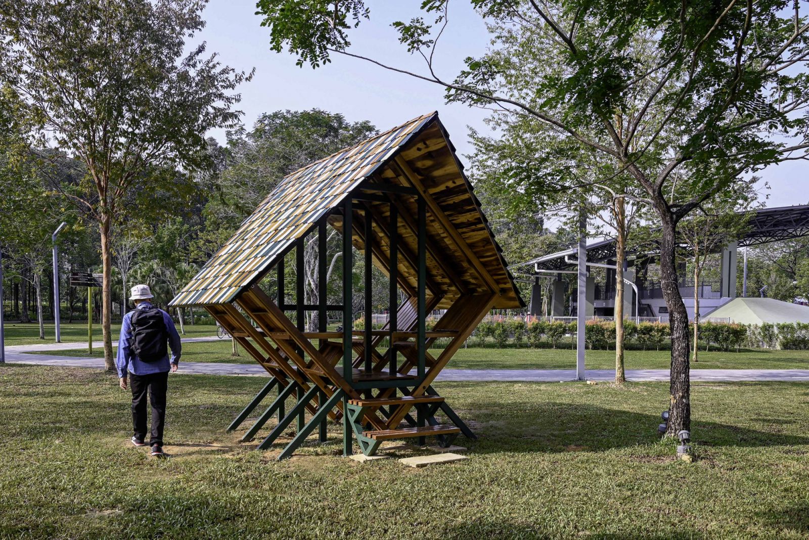 Duduk duduk is a geometric timber pavilion in a public park setting, demonstrating the studio's approach to small-scale interventions that create gathering spaces while experimenting with structural form and material efficiency