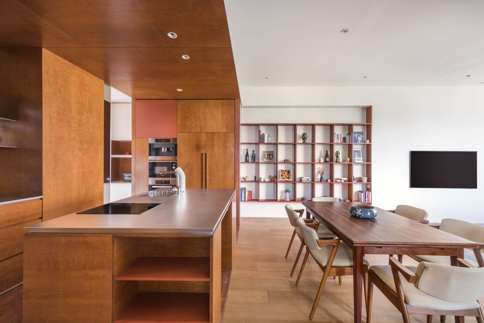 The grid-like wall shelf serves as a simple yet stylish showcase for the owners’ assortment of collectibles and trinkets