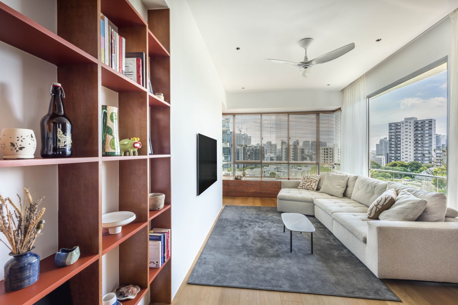 Timber fittings in warm ochre tones and a soothing off-white palette lend snugness and a tangible sense of home to this airy mid-century modern apartment