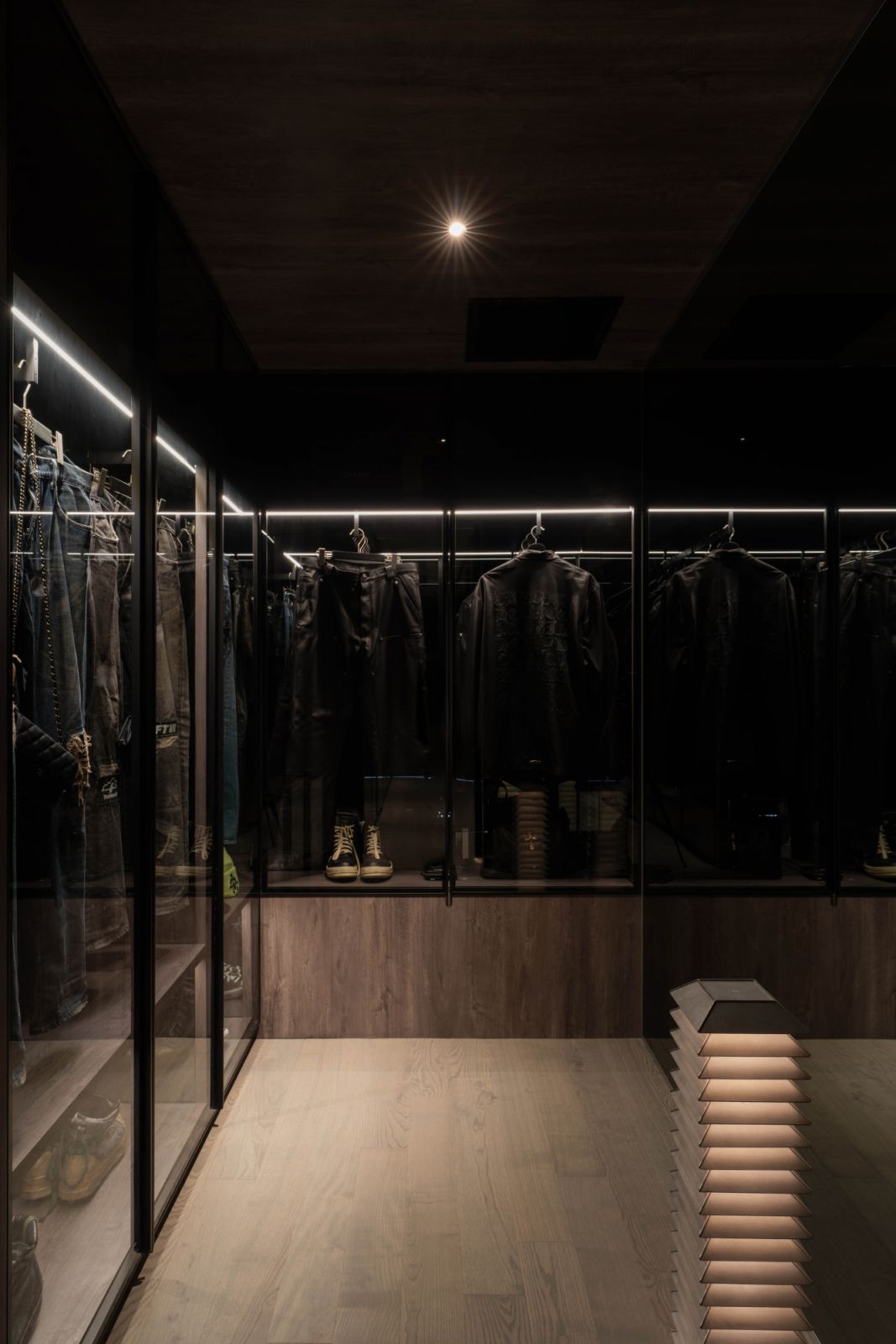 This moody wardrobe conceals a structural column that once obstructed the openness of the layout