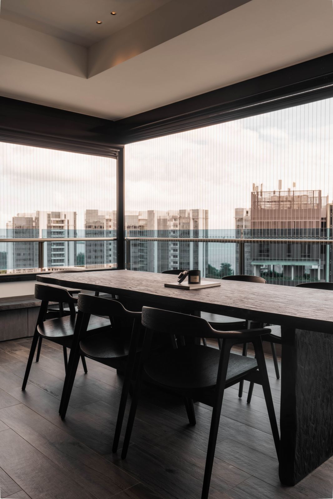 This dark-stained outdoor dining set cuts a striking image against the skyline