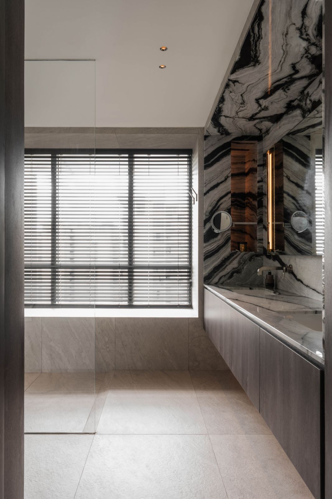 Bold bookmatched marble recurs throughout the abode