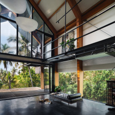 Natural light floods the timber residence’s spacious, double-height living area with large glazed openings