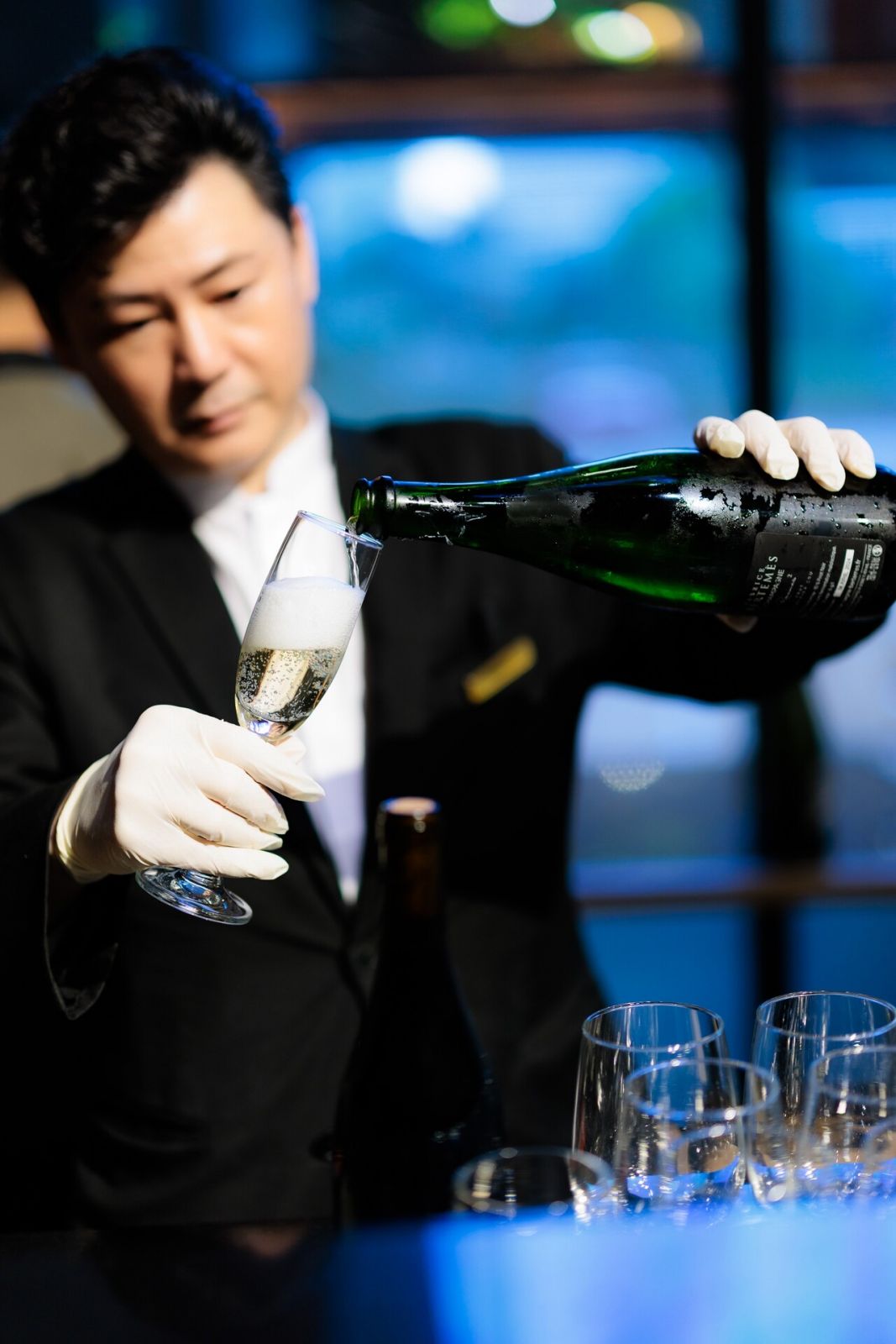 Bartender pouring champagne from Vin-ex Wines and Spirits