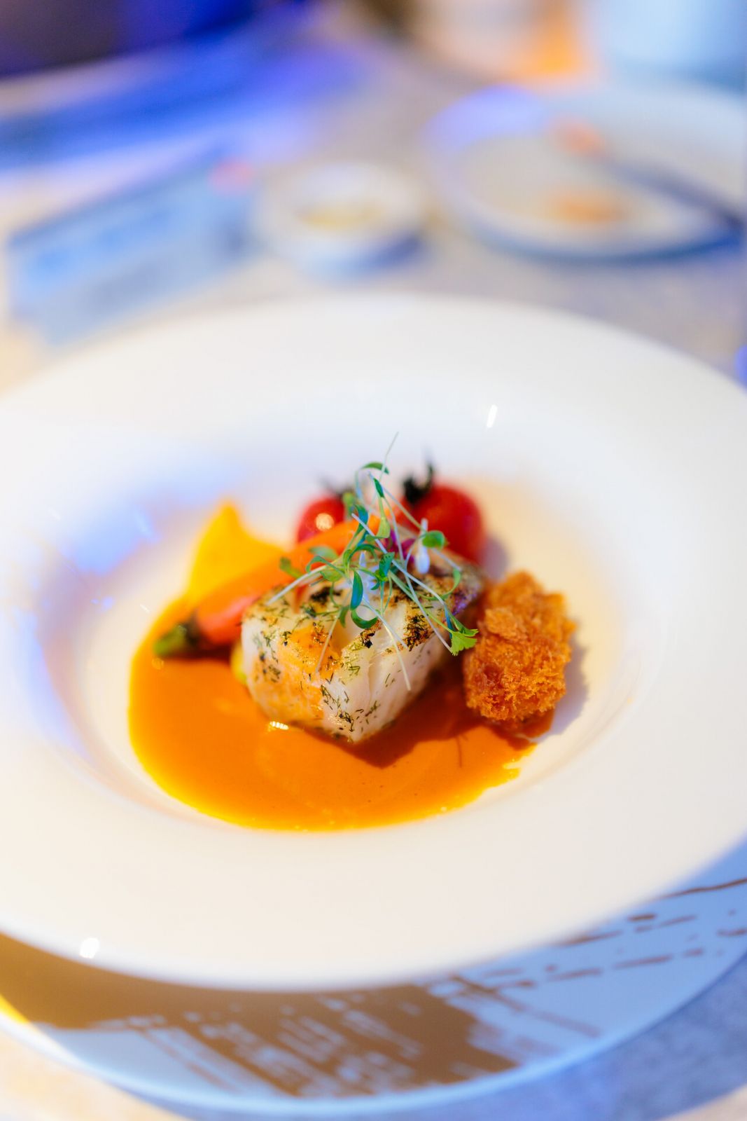 Pan-Fried Cod served with oyster beignet, confit vine tomato, carrot purée and truffle jus