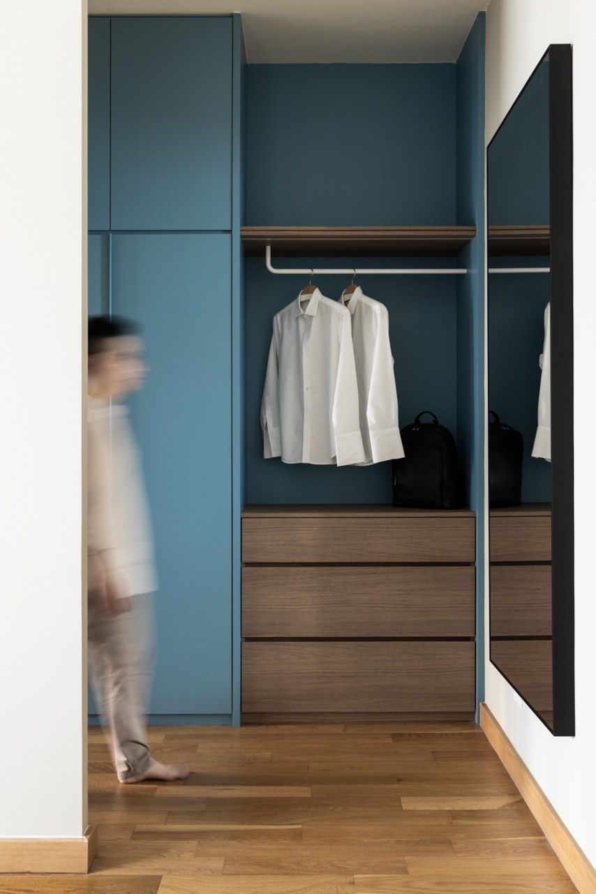 Teal cabinetry pairs with warm timber drawers in the custom storage area, where clean lines meet functional design