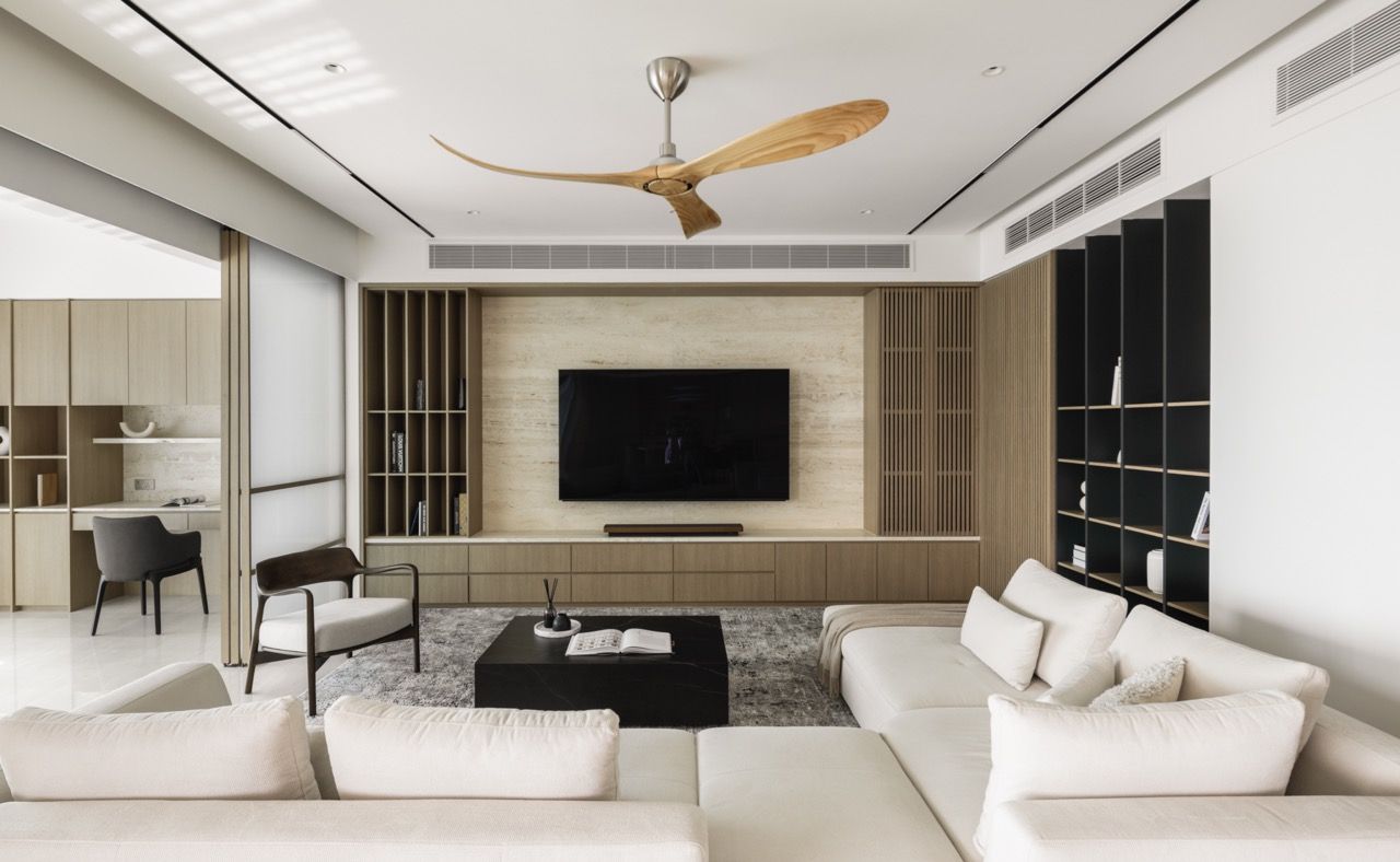 Floor-to-ceiling timber elements maintain visual continuity throughout the apartment.