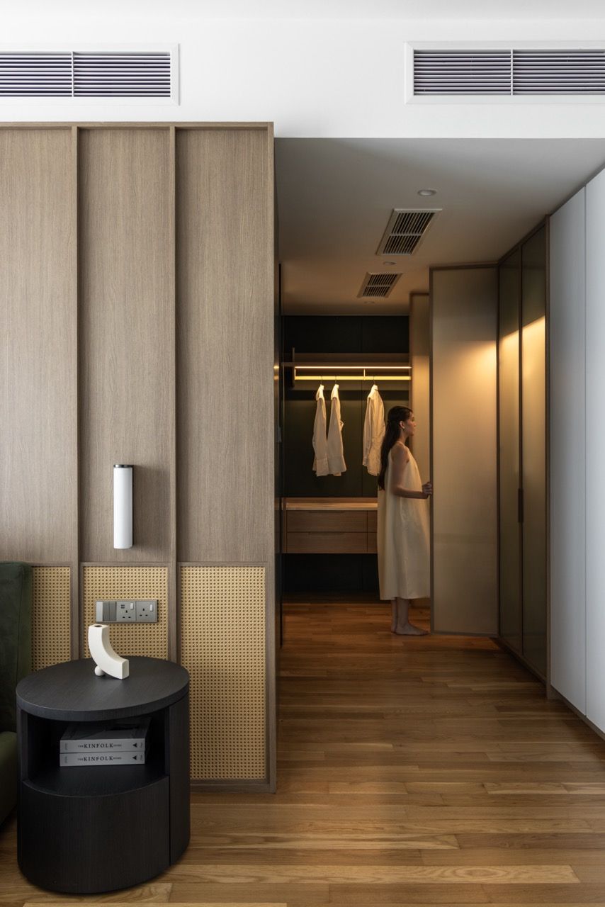 LED strip lighting illuminates the hanging space while maintaining the apartment’s refined material palette