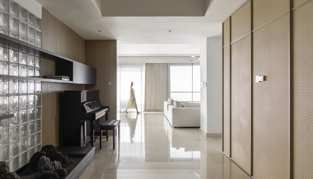 Glass block walls and timber framing create a dedicated music area, showing how the design accommodates specific lifestyle needs