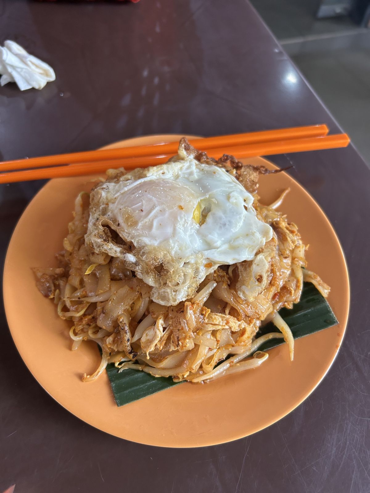 The perfect fried egg atop the bouncy plate of rice noodles