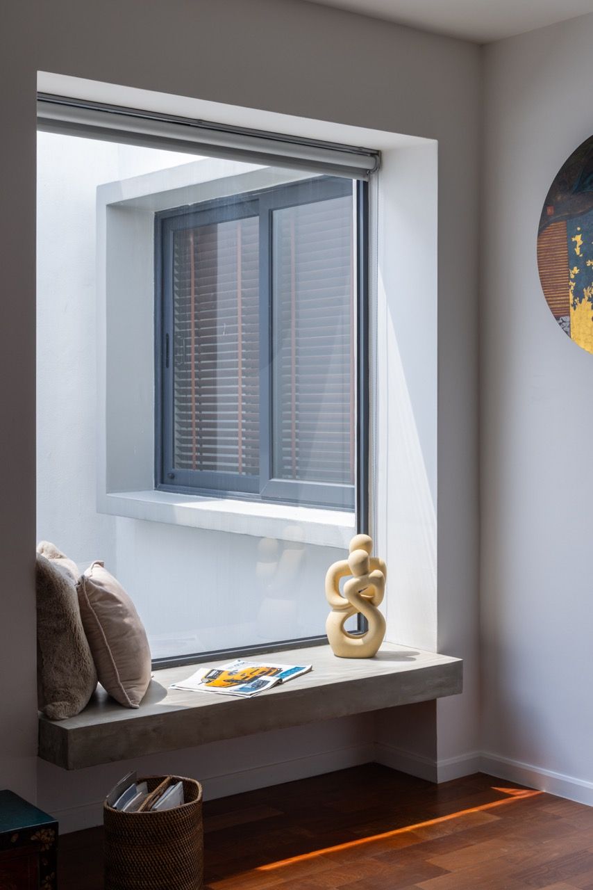 A custom window seat creates a reading nook with views to the neighbouring properties