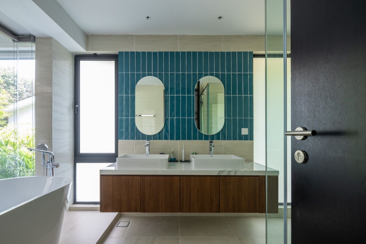 The master bathroom features contemporary fittings with a floating timber vanity and dual basins