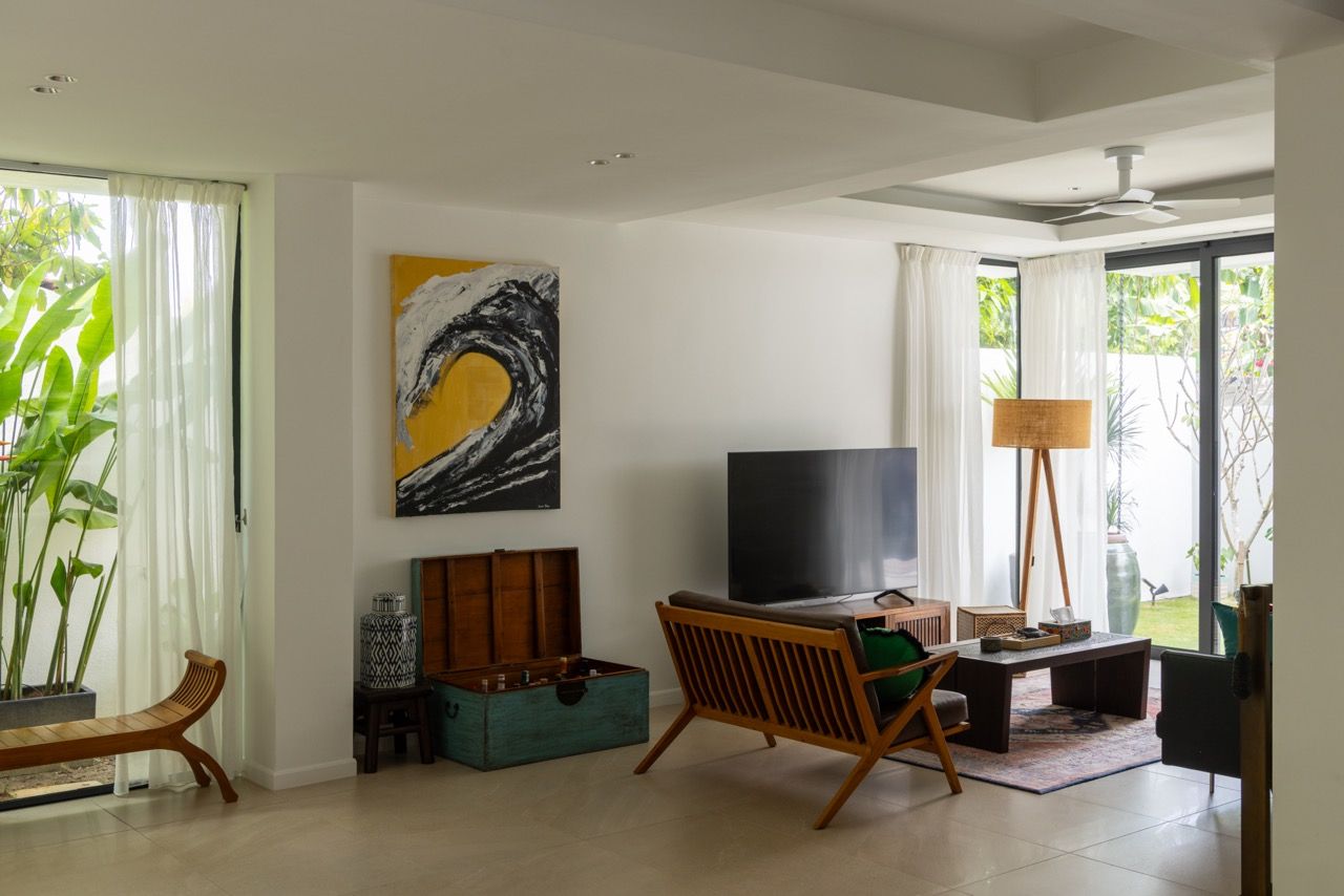 The extended living spaces flow seamlessly between kitchen, dining, and lounge areas, demonstrating how the renovation addressed the original house's cramped room sizes through strategic extensions and openings