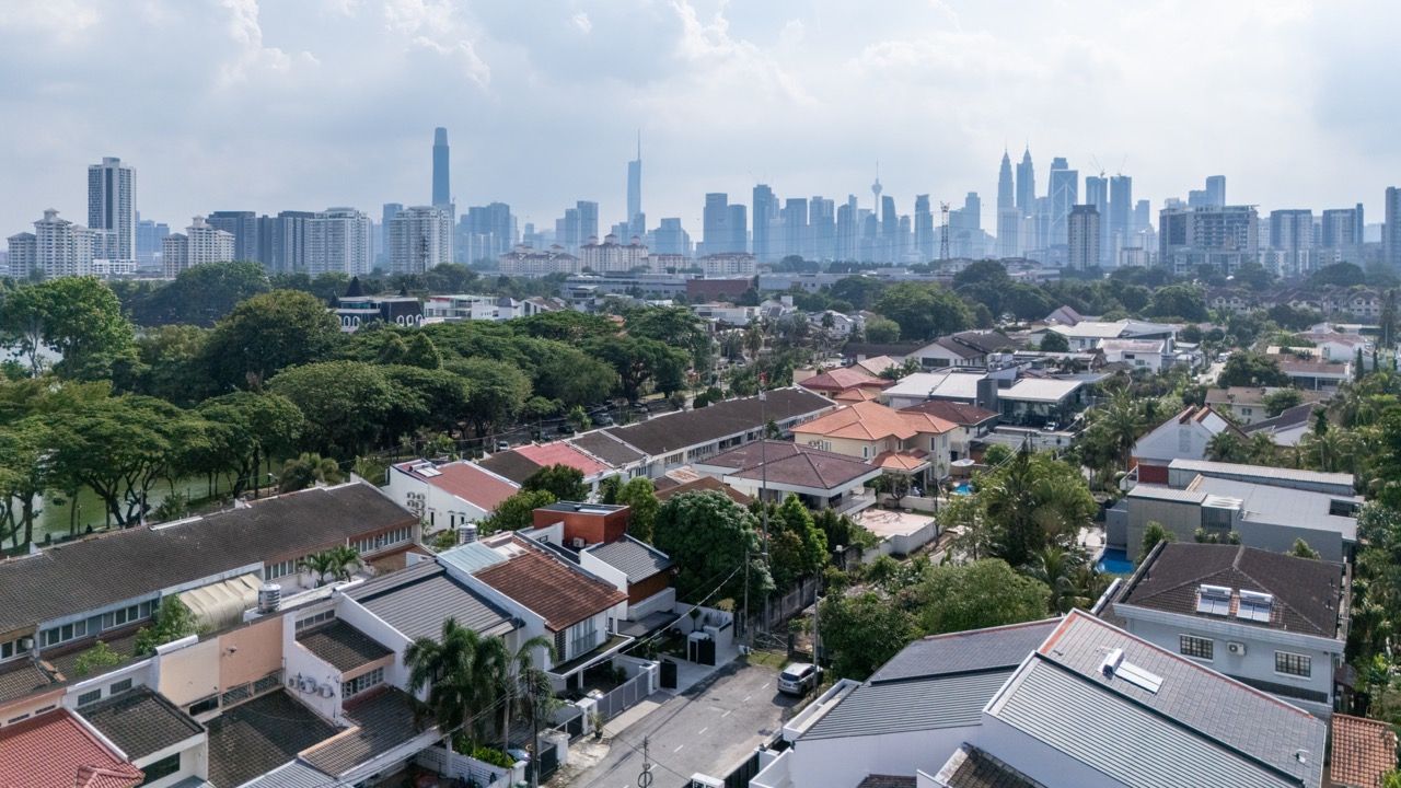 An aerial view reveals the end-lot terrace house's advantageous position with side garden access, providing additional natural light and ventilation