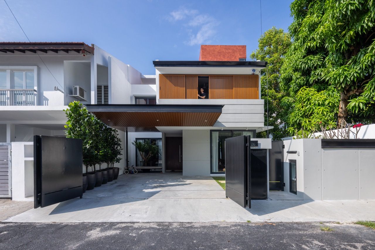 The redesigned front façade features a contemporary entrance with timber louvres and clean lines, contrasting with the original 40-year-old terrace house structure whilst respecting neighbourhood context