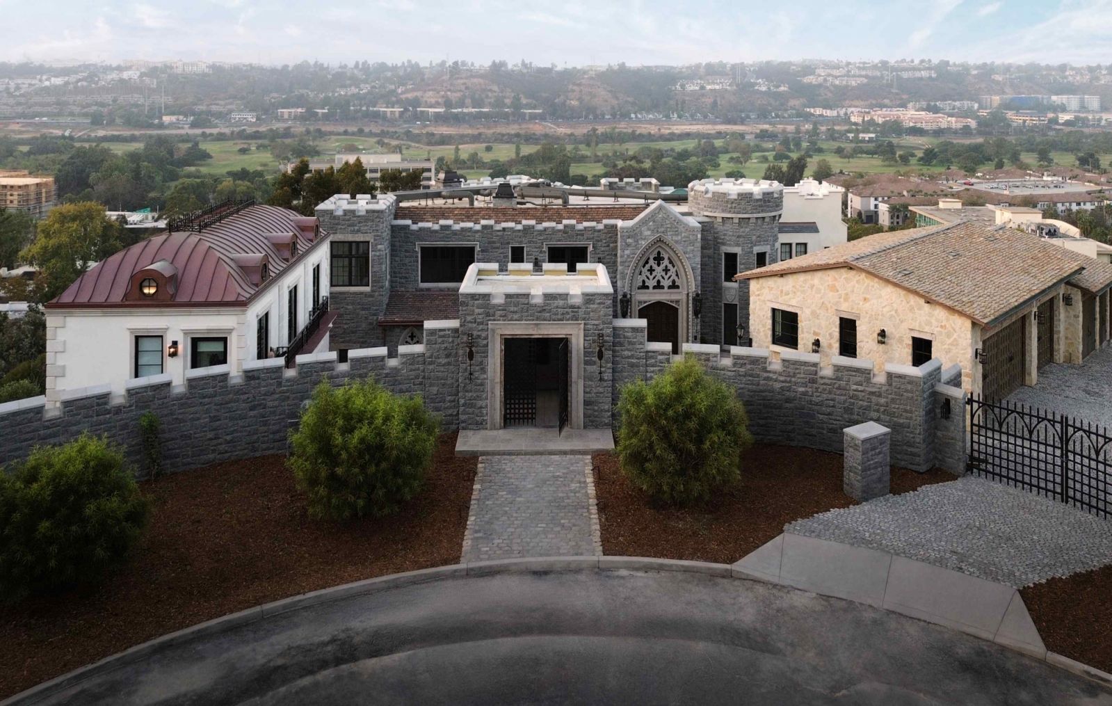 The sprawling castle residence is hidden behind towering stone walls